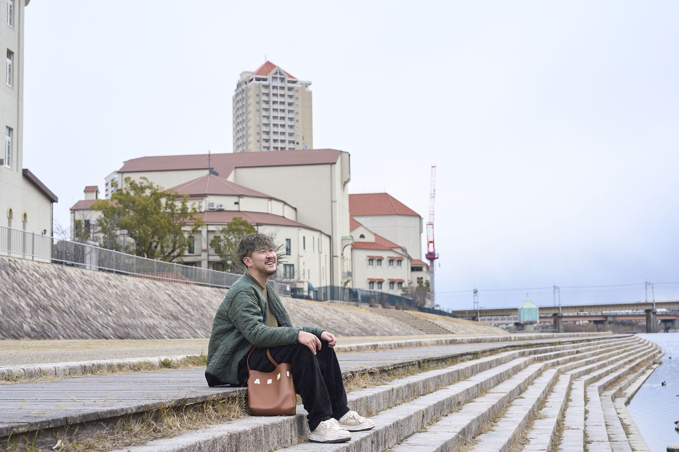 武庫川の河川敷、階段に腰掛けてこれからのことを語る寺地さん